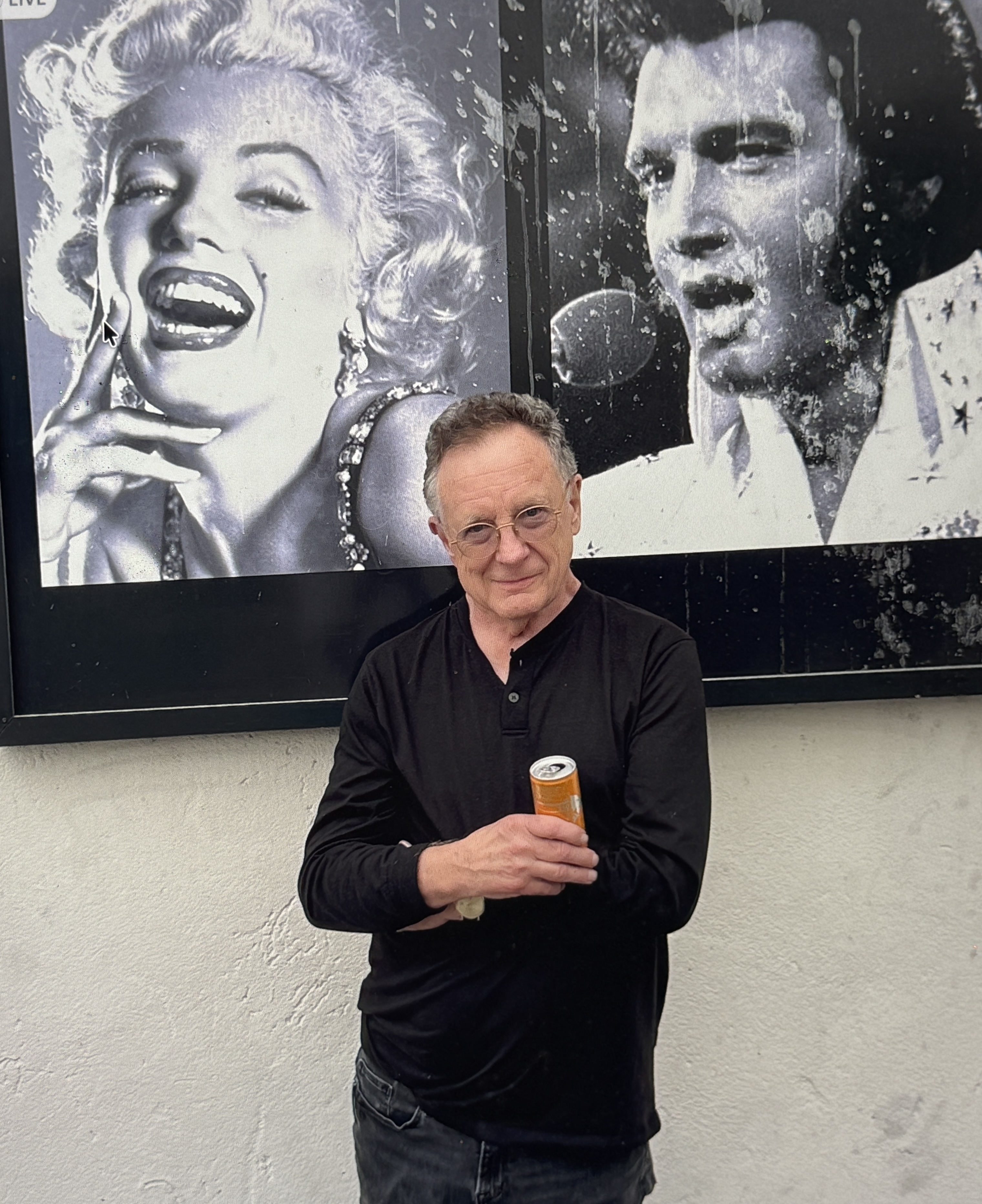 Mike Malak from his Hollywood years at Daily Variety, alongside Marilyn Monroe and Elvis Presley posters