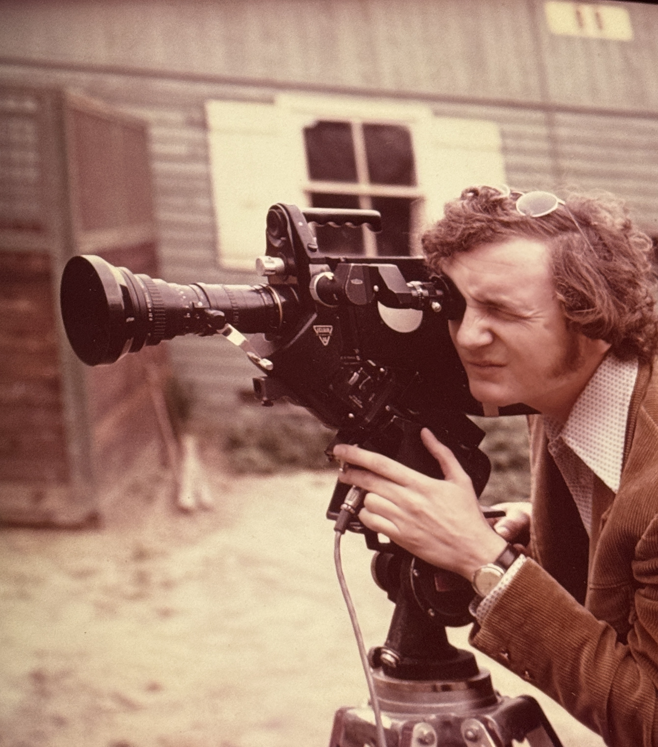 Young Michael Malak operating a professional film camera